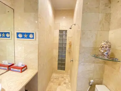 a bathroom with a shower with a toilet and a sink at 2bedroom Apartment Petitenget Beach in Seminyak