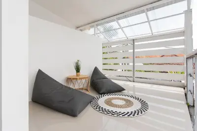 a living room with two pillows and a table at Volare villa in Seminyak
