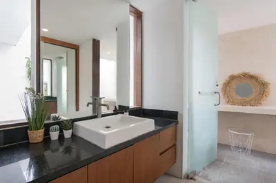 a bathroom with a sink and a mirror at Volare villa in Seminyak