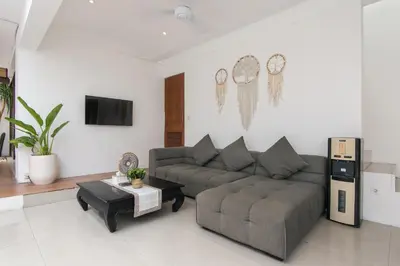 a living room with a couch and a coffee table at Volare villa in Seminyak