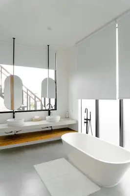a white bathroom with two sinks and a tub at Casa Luna Villa in Kerobokan