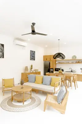 a living room with a couch and tables at Casa Luna Villa in Kerobokan