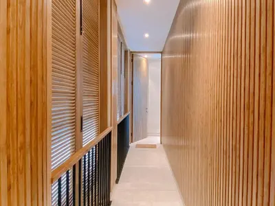 a hallway with wood paneled walls and a walkway at Casa de Rua Villas in Badung