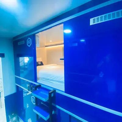 a mirror in a room with a bed in it at Rosalyne Sleepbox Denpasar Bali in Seminyak