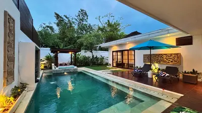 a swimming pool in the backyard of a house at Villa Isabella in Seminyak