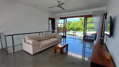 a living room with a couch and a table at Villa Isabella in Seminyak