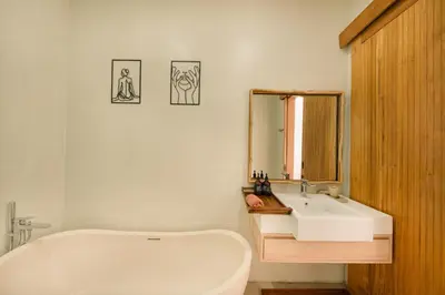 a bathroom with a white tub and a sink at Shanti Villa - 3BR Luxury Private Pool Villa in Seminyak in Seminyak