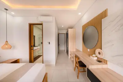 a bedroom with a bed and a mirror on a wall at Shanti Villa - 3BR Luxury Private Pool Villa in Seminyak in Seminyak