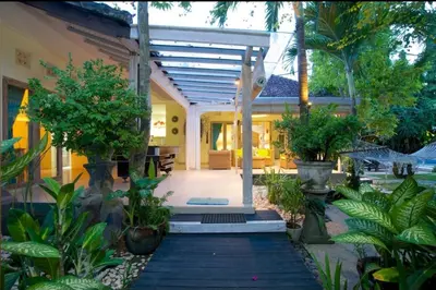 a house with a courtyard with trees and plants at Villa bunny seminyak in Seminyak
