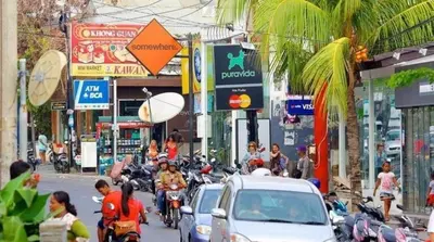 a group of people riding motorcycles on a busy city street at Villa bunny seminyak in Seminyak