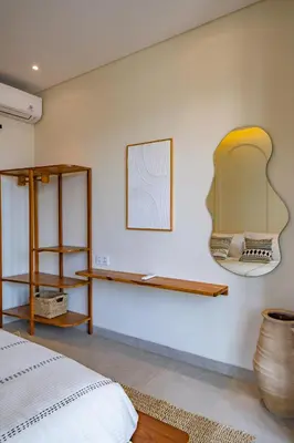 a bedroom with shelves on the wall at Casa Samudra - 3BR Villa in Seminyak in Seminyak
