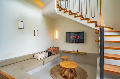 a living room with a couch and a table at Casa Samudra - 3BR Villa in Seminyak in Seminyak