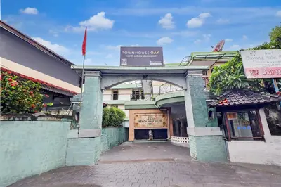 an entrance to a building with a sign above it at Townhouse Oak Legian Near Legian Beach Formerly Sayang Maha Merta in Legian