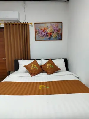 a bedroom with a bed with two pillows at Pondok Mawar in Badung