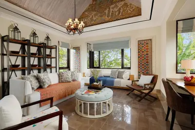 a living room with a couch and a table at Puri Tibo Tanjung Sanur in Sanur