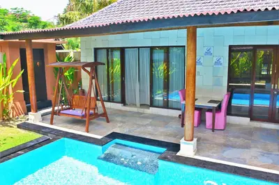 a villa with a pool and a table and a swing at Private Pool Villas Kuta Bali in Kuta