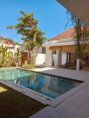 a swimming pool in the yard of a house at Villa Louis Tanjung Benoa in Nusa Dua