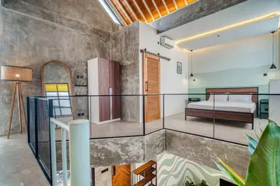 a room with a balcony with a bed in it at Tuju Apartment 1BR Loft in Umalas in Canggu