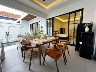 a dining room with a table and chairs at Kamila Villas 2BR Private Pool Seminyak Central in Seminyak
