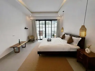 a bedroom with a large bed in a room at Kamila Villas 2BR Private Pool Seminyak Central in Seminyak