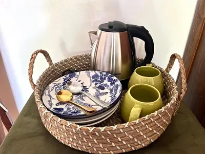 a basket with plates and cups on a table at Modern Guesthouse in Seminyak in Seminyak