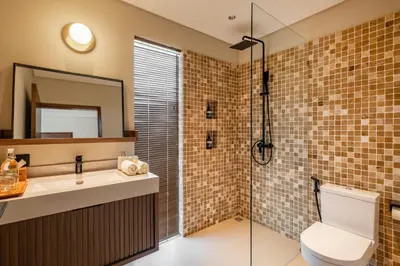 a bathroom with a toilet and a sink and a mirror at Villa Mesra Stunning Paddy Fields Views - Canggu Berawa in Canggu