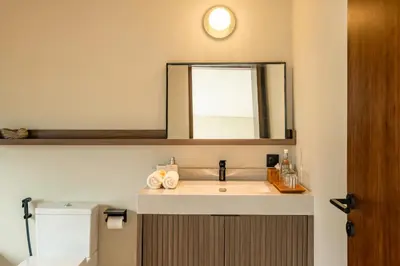 a bathroom with a sink and a mirror at Villa Mesra Stunning Paddy Fields Views - Canggu Berawa in Canggu