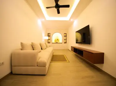 a living room with a couch and a ceiling fan at Near Beach Villa in Seminyak