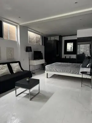 a living room with a bed and a couch at Minimalist apartment long term in Seminyak