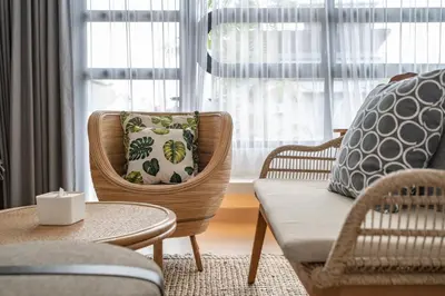 a living room with chairs and a couch and a table at Villa Tibrava Umalas by BaliSuperHost in Canggu