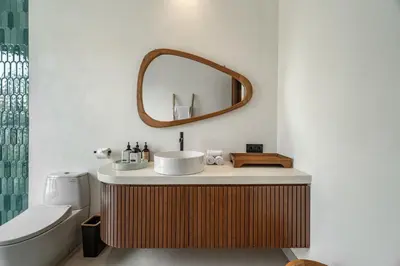 a bathroom with a sink and a mirror on the wall at Villa Tibrava Umalas by BaliSuperHost in Canggu