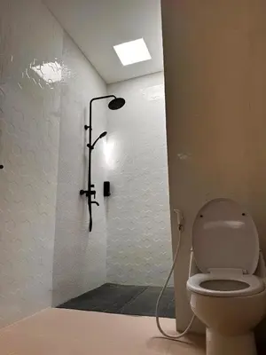 a bathroom with a shower with a toilet at Private Escape in Seminyak in Seminyak