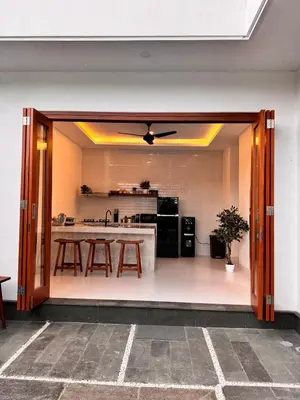 a kitchen with a table and a ceiling fan at Private Escape in Seminyak in Seminyak