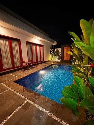 a swimming pool in the middle of a house at Private Escape in Seminyak in Seminyak