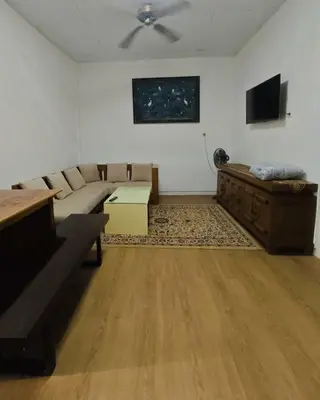 a living room with a couch and a table at Holiday Home Bali in Denpasar