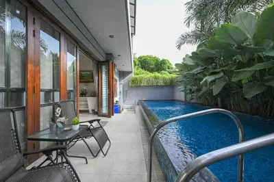 a swimming pool on the side of a house at Puri Ratu Jimbaran with Private Pool in Jimbaran