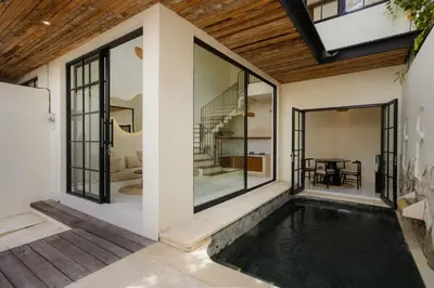 a swimming pool in the middle of a house at Villa Batu Putih 2 Seminyak - No FLOOD in Seminyak