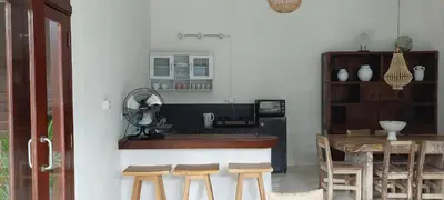 a kitchen with a counter and a table with stools at Seminyak great Location Villa in Seminyak