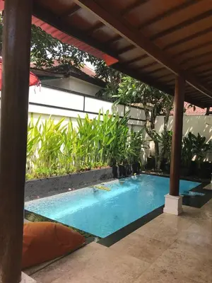 a swimming pool under a pergola at One BedRoom Villa with Private Pool near DPS Airport in Kuta