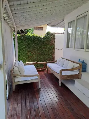 a porch with two beds on a wooden deck at Bear Cottage 4 Bedroom Luxury Villa - Petitenget, Seminyak in Seminyak