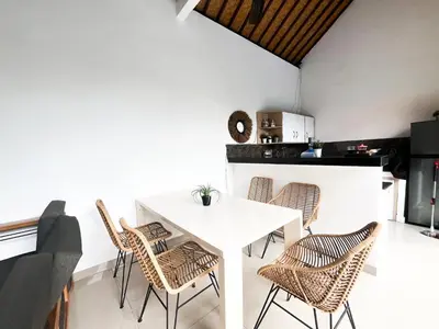 a dining room with a white table and chairs at Villa Kita Seminyak in Seminyak