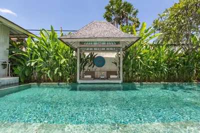 a gazebo sitting next to a swimming pool at Villa Sky Li by Nagisa Bali in Seminyak