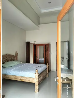 a bedroom with a large bed in a room at Villa Sanur2 in Sanur