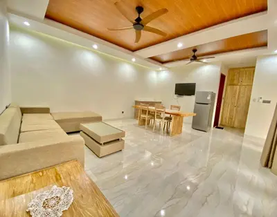 a living room with a couch and a table at Villa Sanur 3 in Sanur