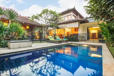 a swimming pool in front of a house at Villa Bali Caviar in Seminyak