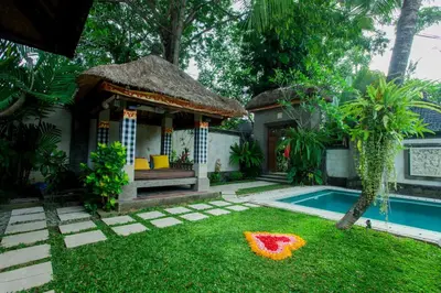 a small house with a pool and a garden at Villa Dewata II in Seminyak