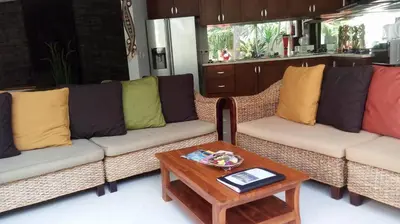 a living room with two couches and a coffee table at Villa Rendezvous Bali in Seminyak