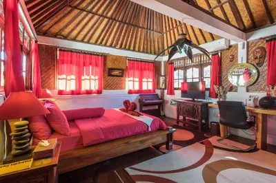 a bedroom with a bed and a desk in a room at Villa Blue - 4BR authentic and atypical villa in Seminyak in Seminyak
