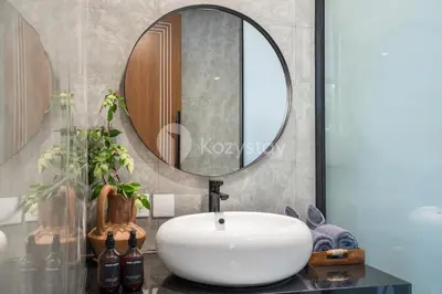 a bathroom with a white sink and a mirror at Kros Villa by Kozystay - Legian in Legian