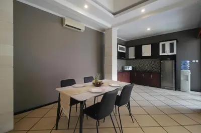 a kitchen and dining room with a table and chairs at Jayani Villa Seminyak byFaba in Seminyak
